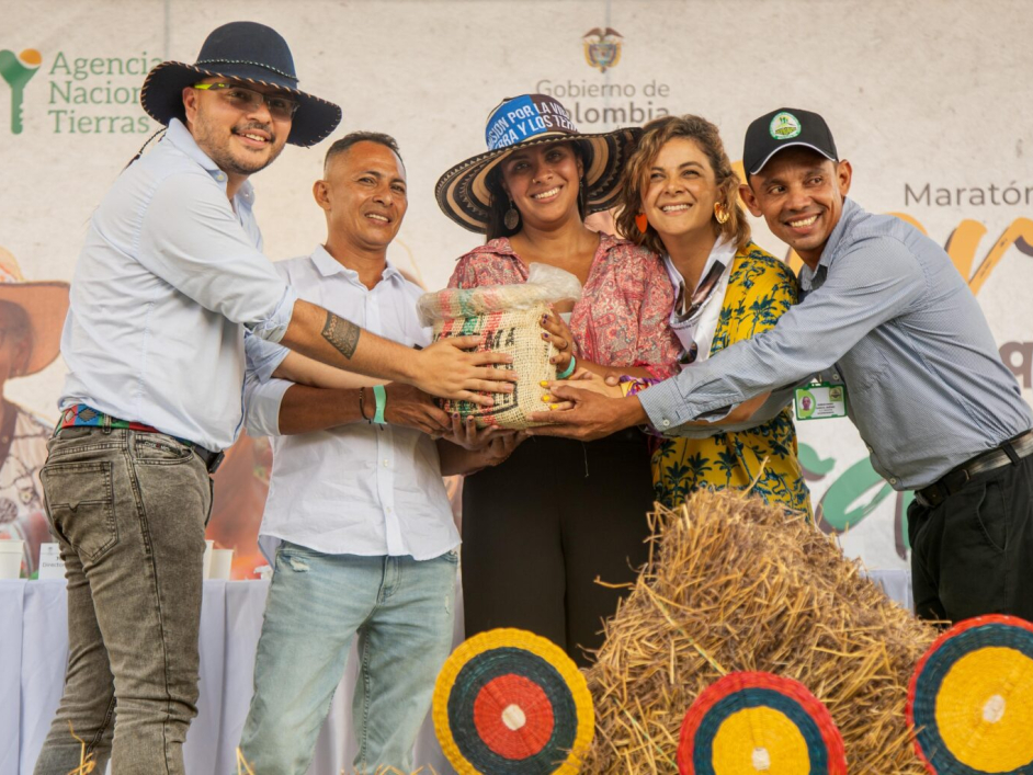 Campesinos durante el acto de entrega junto a la Ministra de Agricultura y el Director de la ANT.